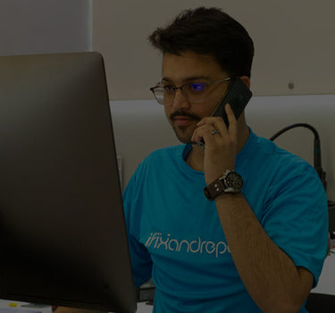 iFixandRepair technician assisting customer over the phone in front of computer