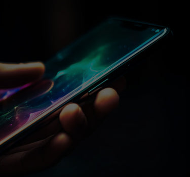 A hand holding a smartphone