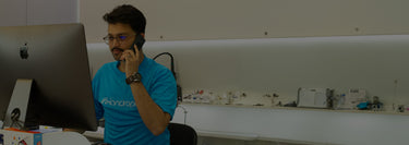 iFixandRepair technician assisting customer over the phone in front of computer