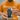A technician wearing an orange iFixandRepair t-shirt showing the back of an opened iPhone