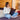 Woman using a laptop on a couch in a cozy living room.