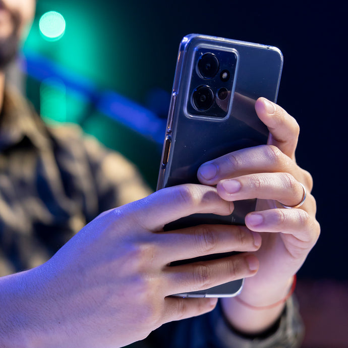 Person holding a smartphone with a blurred background